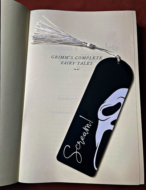 What's your favourite scary book?  Mark your page with this ghost face bookmark, the perfect gift for any horror bookworm. Handmade to order  using high quality, 3mm thick laser cut acrylic layered with permanent vinyl design and a colour co-ordinated tassel.   The design is on one side only, the other side will be left blank.  -----Size-----  15cm length x 5cm width x 3mm depth I'd love to see your photos so please tag us @helheimhomewares on Instagram.   Free delivery included -----Custom colo Book Mark Inspo Aesthetic, Science Bookmark Ideas, Book Mark Drawings, Cool Book Mark Ideas, Scream Bookmark, Bookmark Handmade Ideas, Thriller Bookmarks, Book Marks Design, Scary Bookmarks