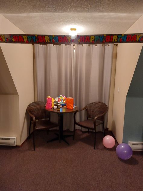 a hotel room with a banner across the top that says happy birthday. there's two empty chairs, some balloons on the floor, and goodie bags on the table in the center. Horror Images, Object Painting, Strangely Familiar, Surreal Places, Brain Parts, Familiar Places, Core Board, Space Birthday Party, Sgt Pepper