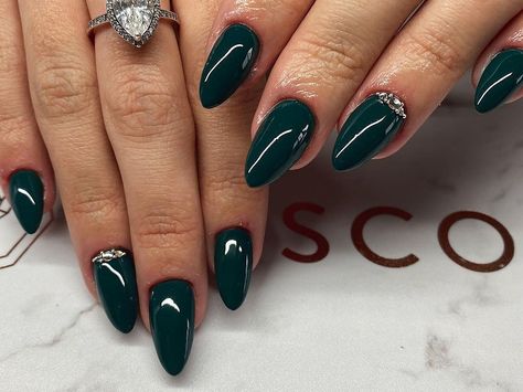 Nails With Gems Almond, Dark Green Nails Almond Shape, Dark Green Almond Acrylic Nails Designs, Dark Green Almond Acrylic Nails, Almond Nails Gems, Green Nails With Gems, Dark Green Pointy Nails, Dark Green Almond Nails, Forest Green Stiletto Nails