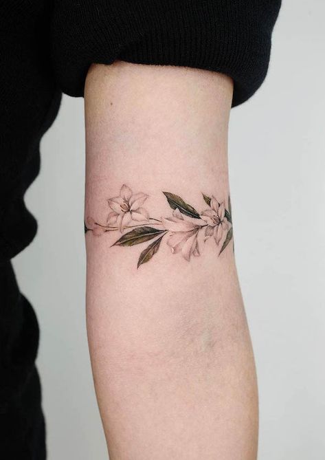 37 Stunning Armband Tattoos For Women - Our Mindful Life Wrap Around Tattoos For Women Arm, Lily Arm Band Tattoo, Floral Arm Band Tattoo For Women, Minimal Arm Tattoos For Women, Arm Cuff Tattoo For Women, Upper Arm Wrap Tattoos For Women, Armband Tattoo For Women, Wrap Around Tattoos, Flower Band Tattoo