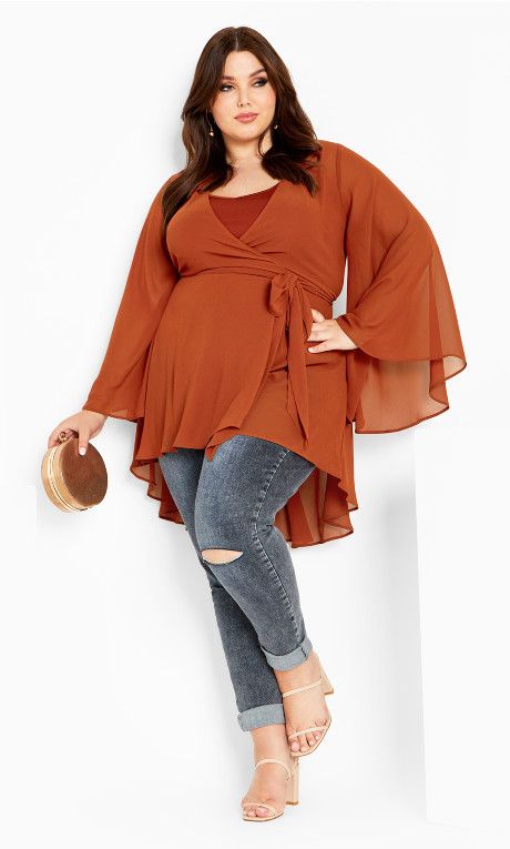 Dial up your styles with the Fleetwood Tunic! Floaty and feminine, this tunic hugs your curves with a V neckline wrap around style, hi-lo longline wrap hemline and flutter bell sleeves that adds a dreamy finish.   Key Features Include: - V-neckline wrap around style - Flutter bell sleeves - Wrap waist with side tie - Hi-lo longline wrap hemline - Floaty chiffon fabrication with subtle stretch - Slip included  Coordinate with a sleek handbag! Size 16 Women, Womens Style, Androgynous Fashion, Fashion Tips For Women, Style Tips, City Chic, Long A Line, Feminine Style, Wrap Around