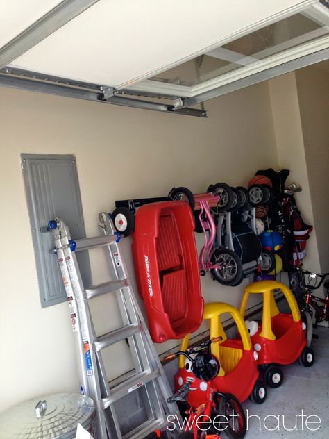 Source: SweetHaute.blogspot.com 9. Garage Track System Let’s not forget about the other play area, your garage. I personally have a Cozy Coupe, tricycle, baby doll stroller, and variety of other ridable toys that park right next to my grown up car. If we get many more toys, there’s going to be a turf war. TheContinue Reading... Outdoor Toy Storage, Garage Boden, Baby Toy Storage, Garage Floor Paint, Toy Garage, Garage Organize, Radio Flyer, Garage Makeover, Garage Storage Organization