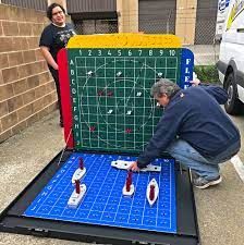 Giant Battleship Game - Event Party Rental Video Amusement California Giant Battleship Game, Battleship Float Ideas, Battleship Game Decorations, Giant Battleship Game Diy, Lifesize Board Games, Board Game Parade Float Ideas, Board Game Float Ideas, Battleships Game, Wedding Barrels