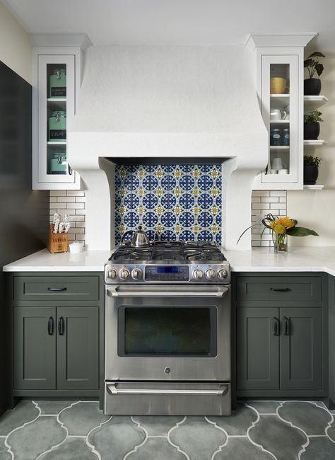 Fun tile as range backsplash and focal point. Nice hood vent and a mix of cabinetry. Mexican Kitchen Decor Ideas, Colonial Revival Kitchen, Plaster Range Hood, Spanish Tile Kitchen, Spanish Tile Backsplash, Modern Spanish Colonial, Spanish Revival Kitchen, Spanish Colonial Kitchen, Range Hood Ideas