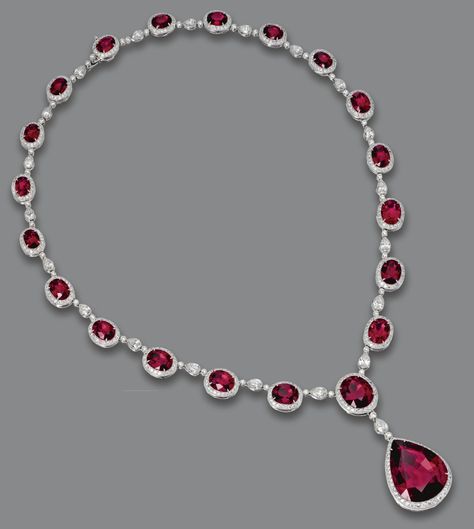 RUBELLITE AND DIAMOND NECKLACE.  The graduating necklace composed of 20 oval rubellites weighing approximately 29.80 carats, the center supporting a pear-shaped rubellite weighing 21.77 carats, all within borders of 21 pear-shaped  diamonds and numerous round diamonds weighing a total of approximately 9.00 carats, mounted in platinum, length 16¼ inches. Solitaire Pendant Necklace, Diamond Jewelry Necklace, Ruby Jewelry, White Gold Jewelry, Pear Shaped Diamond, I Love Jewelry, Red Ruby, Van Cleef, Dream Jewelry