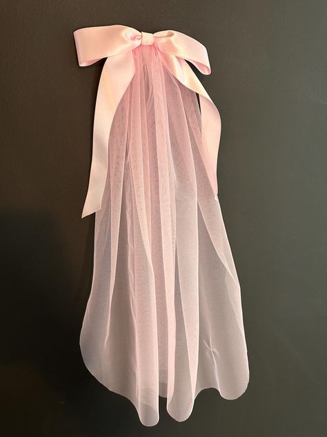 Hand made, Pink 22" tulle veil.  Finished with a comb for fitting, and a satin bow. Available with our without personalisation.  Any personalisation available. Find us on Facebook: https://www.facebook.com/SilkandSage.info/ Wedding Vail With Bow, Pink Wedding Veil, Pink Wedding Viel, Pink Bow Hair Accessories For Wedding, Bow Viel, Pink Satin Wedding Bow, 80s Wedding, Pink Veil, Dreamy Whites