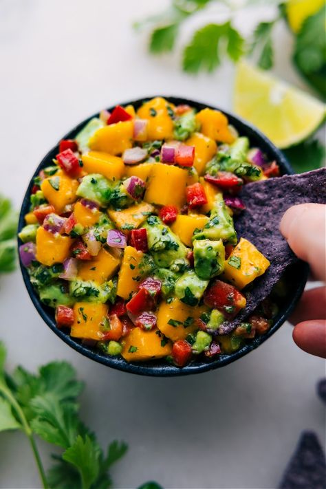 Our Mango Salsa is the recipe we reach for when mangoes are at their peak of ripeness! It's an effortless blend that's brimming with flavor Snack Quick, Mango Avocado Salsa, Chelsea's Messy Apron, Cilantro Lime Chicken, Avocado Salsa, Summer Dishes, Chips Recipe, Mango Salsa, Salsa Recipe