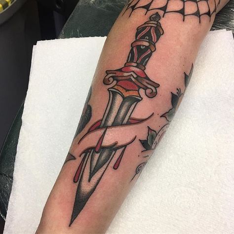 Traditional, dagger stabbed arm tattoo Pirate Themed Tattoos, Rose And Dagger Tattoo, Belfast Tattoo, Traditional Dagger Tattoo, Traditional Dagger, Blade Tattoo, Pirate Tattoo, Rose Tattoos For Men, Knife Tattoo