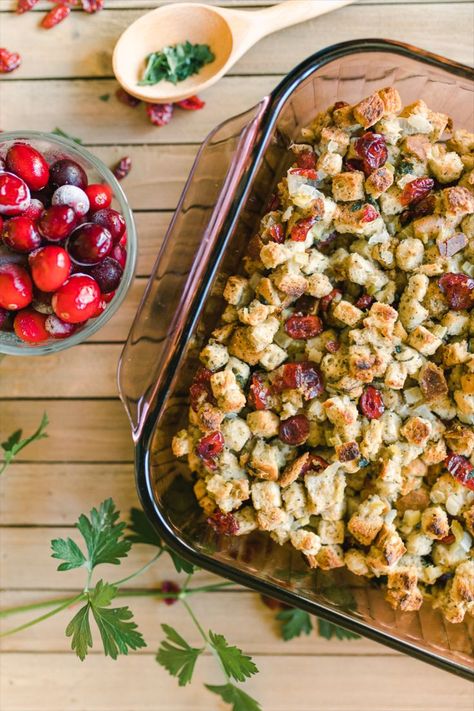 A pan of baked cranberry stuffing with a side dish of frozen cranberries. Stuffing With Cranberries, Recipe With Cranberries, Traditional Stuffing Recipe, Traditional Stuffing, Cranberry Stuffing, Best Thanksgiving Appetizers, Michigan Food, Traditional Thanksgiving Recipes, Bread Dressing