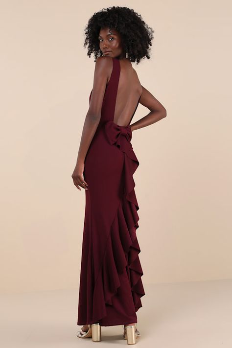 The Lulus Exquisite Refinement Plum Purple Backless Bow Ruffled Maxi Dress is a luxurious design that was made to ensure all eyes are on you when you step into the room! You'll look fabulous all night long with this stretchy crepe knit dress that features a sophisticated boat-style neckline and a sleeveless bodice with an alluring open-back design. The fitted waist tops a figure-flaunting, mermaid-style skirt that falls to a sweeping maxi hem. A trendy bow detail and cascading ruffles accent the back of the skirt for a gorgeous finish! Fit: This garment fits true to size. Length: Floor length. Size medium measures 58.75" from shoulder to hem. Bust: Great for any cup size. Waist: Fitted - very fitted at natural waist. Hip: Fitted - stretchy fabric allows room for hips. Undergarments: May be Plum Gown Long Dresses, Plum Maid Of Honor Dress, Plum Bridesmaid Dresses Fall, Floral Bridesmaid Dresses Plum Pretty Sugar, Plum Backless Dress, Chic Purple Floor-length Maxi Dress, Plum Bridesmaid Dresses, Fitted Prom Dresses, Trendy Bows