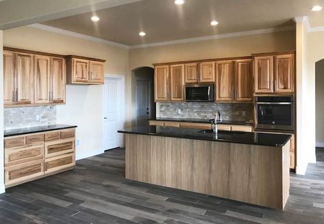 Kitchen with hickory cabinets dark vinyl floors and black granite counters Kitchen With Hickory Cabinets, Natural Hickory Cabinets, Rustic Hickory Cabinets, Framed Kitchen Cabinets, Kitchen Cabinets And Flooring, Kitchen Cabinet Sizes, Frameless Kitchen Cabinets, Best Flooring For Kitchen, Hickory Kitchen Cabinets