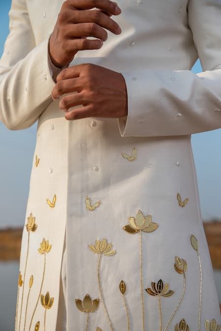 Buy Ivory Sherwani Chanderi Silk Bloom Applique Embellished And Kurta Set For Men by Runit Gupta Online at Aza Fashions. Hand Work Motifs, Mens Hand Painted Kurta, Mens Embroidered Kurta, Men Carnival Outfit, Hand Painted Kurta For Men, Haldi Outfit For Men, Traditional Indian Mens Clothing, Ivory Sherwani, Kurtas For Men