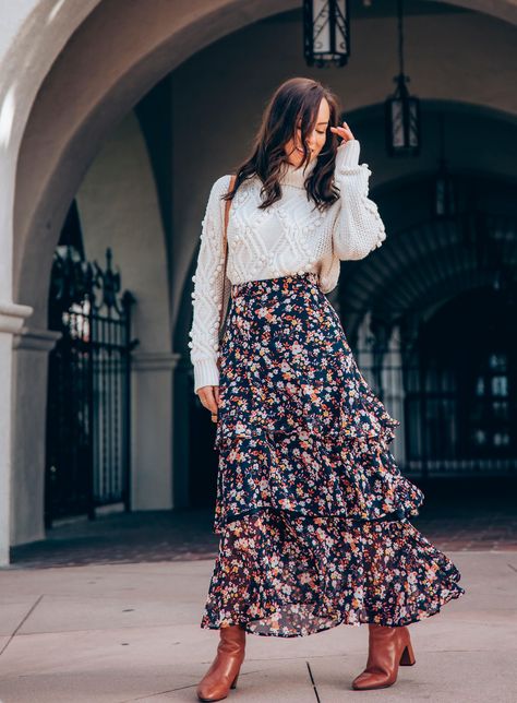 Sydne Style shows how to wear a maxi skirt for winter with chunky knits #turtleneck #maxiskirt #florals #knits @sydnesummer Turtleneck Maxi Skirt, Floral Maxi Skirt Outfit Winter, Long Skirt For Winter Outfits, Layered Midi Skirt, Crop Sweater Over Dress, Floral Dress Outfit Winter, How To Wear Skirts In Winter, Sweater Over Maxi Dress, Long Skirts Winter