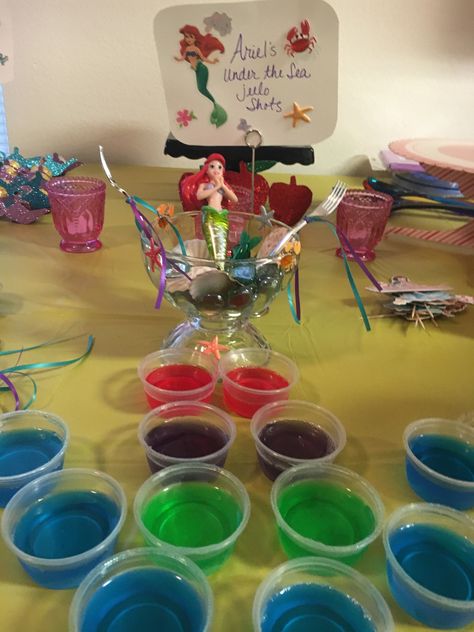 jello-shots with Titos Vodka and some with Smirnoff Whipped Cream Vodka. Red for her hair, purple for her shells, green for her tail and blue for the ocean. My adult Disney Princess 40th Birthday Party. Disney Themed 18th Birthday Party, Disney Theme 30th Birthday, Disney Themed 21st Birthday Party Ideas, Disney Princess Party For Adults, Disney 18th Birthday Party, Disney Themed 30th Birthday Party, Disney Birthday Party For Adults, Disney 30th Birthday Party, Disney Theme Party For Adults