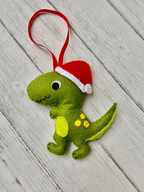 a colorful dinosaur ornament of felt with a cone hat is a fun and bold idea for winter, your kids will be very happy Unusual Christmas Decorations, Dinosaur Christmas Ornament, Dinosaur Christmas Tree, Yellow Dinosaur, Ornaments Diy Kids, Fabric Christmas Decorations, Felt Christmas Tree Decorations, Colorful Dinosaur, Dinosaur Ornament