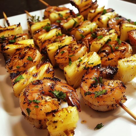 Grilled Jerk Shrimp and Pineapple Skewers 🍤🍍 Experience the perfect blend of spicy and sweet with these Grilled Jerk Shrimp and Pineapple Skewers. This dish is ideal for a summer barbecue or a flavorful dinner. Ingredients: 1 lb large shrimp, peeled and deveined 2 cups fresh pineapple chunks 3 tablespoons jerk seasoning 2 tablespoons olive oil 2 tablespoons lime juice 1 tablespoon honey Fresh parsley or cilantro, chopped for garnish Wooden or metal skewers Preparation: Prepare the Marinade: ... Jumbo Shrimp Skewers, Grilled Jerk Shrimp, Shrimp Kebab, Shrimp And Pineapple Skewers, Skewers On The Grill, Shrimp And Pineapple, Grilled Skewers, Pineapple Skewers, Jerk Shrimp