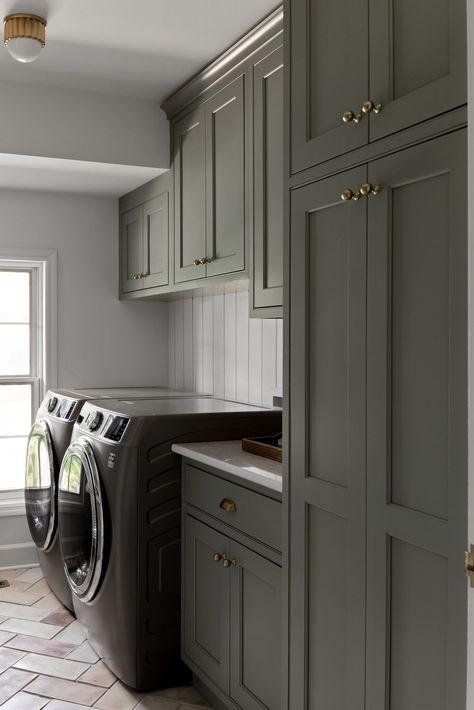 We love a warm laundry room! This authentic laundry space features charming herringbone floors and custom cabinets - all by Hannesson Home Interiors. We’re a full service design firm in Billings, Montana. Servicing the greater Yellowstone area, including Boise, Idaho Falls, Whitefish and Pocatello. Room Cabinet Design, Closet Design Plans, Cottage Laundry Room, Laundry Room Appliances, Laundry Room Cabinet, Laundry Room Paint Color, Herringbone Floors, Laundry Room Paint, Interior Deisgn