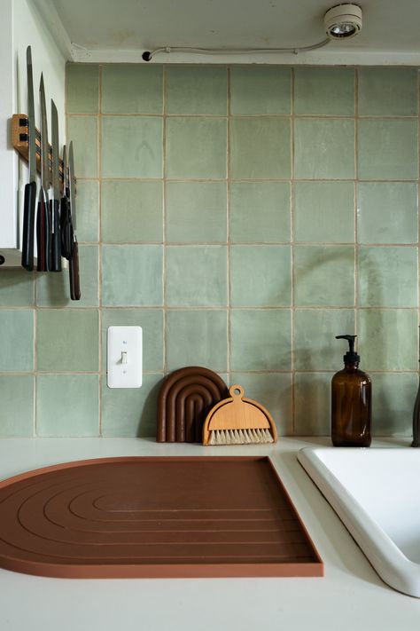 Kitchen with green square tile and white countertops Green Square Backsplash, Green Tile White Cabinets, Green Zellige Tile Kitchen Backsplash, Green Tile Wood Kitchen, Green Tile White Kitchen, White And Green Tiles Kitchen, Tile Over Countertops, Pale Green Kitchen Backsplash, Pale Green Backsplash