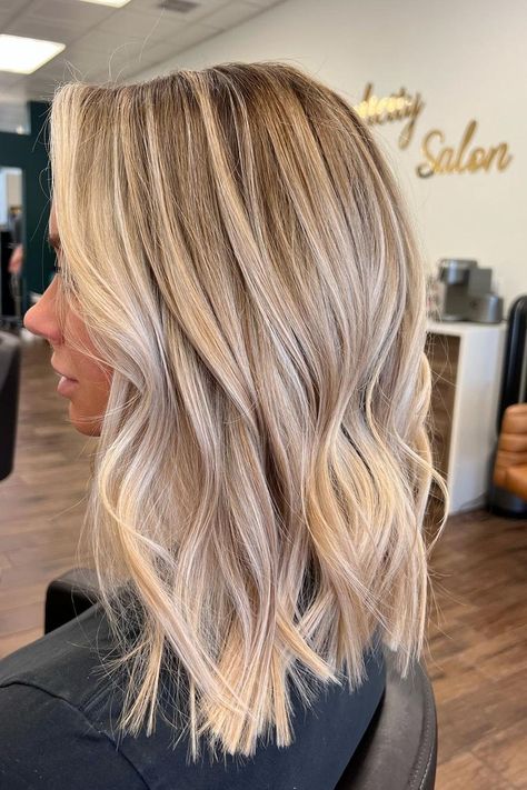 Medium-length layered cut with soft waves, featuring a blend of honey blonde and ash highlights that create a dimensional and vibrant look. The subtle layers add movement and volume, perfect for a fresh and modern style.  // Photo Credit: Instagram @hellobalayage Light Brown Balayage Blonde Highlights, Blonde Bayalage For Fall, Medium Length Highlighted Hair Blonde, Medium Length Hair With Blonde Balayage, Blonde Hair Balayage Medium Length, Dimensional Blonde Long Bob, Blonde Balayage With Dark Lowlights, Dark Blonde And Light Blonde Highlights, Medium Blonde Hair Length