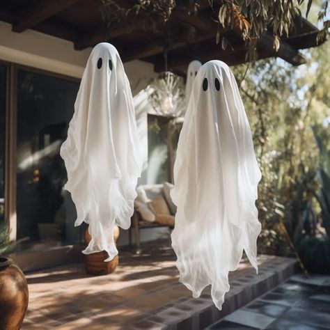 ghost decorations halloween Ghosts Hanging From Tree, Diy Tree Ghosts, Halloween Tree Decorations Outdoor Diy, Halloween Trellis, Hanging Ghosts From Trees, Hanging Ghosts Diy Outdoor, Tree Ghosts Hanging Diy, Diy Hanging Ghost Outside, Outdoor Skeleton Ideas