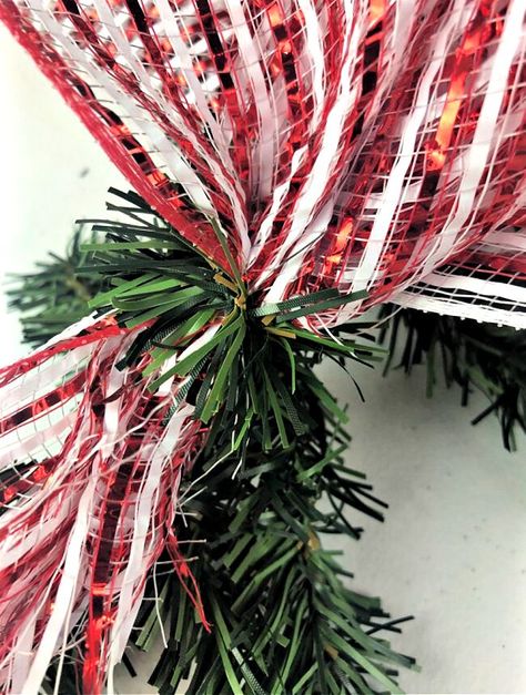 Check out this quick candy theme Christmas garland idea you can make for cheap. Decorate your front porch for Christmas with this easy diy idea. Outside Garland Christmas Porch Ideas, Front Porch Christmas Garland Ideas, Candy Theme Christmas, Outdoor Christmas Garland, Porch Garland, Mesh Garland, Deco Mesh Garland, Outdoor Garland, How To Make Garland