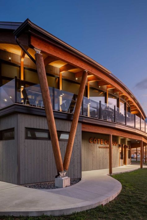 This microbrewery building is entirely made of glued laminated timber. This distinctive architecture gives the beams different profiles. The connectors hidden in the wood are therefore adapted to each of the beams. The exterior round glulam columns are reminiscent of ship masts. Photo credit : Stéphane Groleau. Wood Structure: Art Massif Beam And Column Structure, Wood Architecture Design, Mass Timber Structure, Timber Buildings Architecture, Ship Building Architecture, Wood Structure Detail, Heavy Timber Architecture, Column Design Exterior Architecture, Exterior Column Design