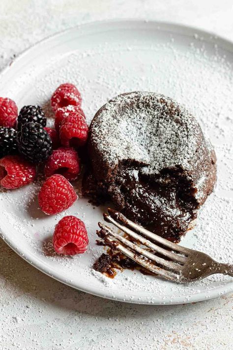 Chocolate lava cake on a white plate with a fork and raspberries. Molten Lava Cakes Recipe, Chocolate Lava Cakes, Molten Lava Cake, Chocolate Lava Cake Recipe, Brown Eyed Baker, Molten Chocolate Lava Cake, Lava Cake Recipes, Molten Lava Cakes, Molten Chocolate