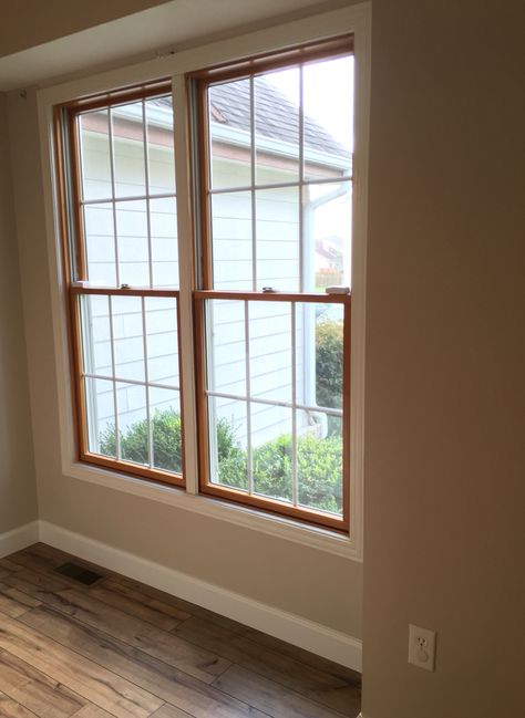 Wood windows, white trim. Shaw laminate floor in lumberjack hickory Wood Windows With White Trim, Wood Windows White Trim, Wood Doors White Trim, Dark Oak Wood Floors, Painted Interior Door, White Hardwood Floors, Farmhouse Trim, Dark Wood Bathroom, Oak Windows