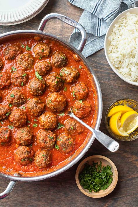 Seasoned with warm spices and simmered in a zesty tomato sauce, these Moroccan meatballs are full of flavor and easy enough for a weeknight meal. Serve with a side of rice or couscous and roasted carrots for a complete meal. Meatball Tagine Recipes, Moroccan Meatballs Recipes, Easy Moroccan Recipes, Couscous Meatballs, Meatballs And Couscous, Meatballs Couscous, Moroccan Food Recipes, Tomato Meatballs, Middle Eastern Meatballs