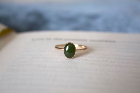 STUNNING 14k gold filled or Sterling Silver handmade Nephrite Jade ring ✨ * Listing covers the single Nephrite Jade ring, other rings shown are sold separately.   Beautiful 8x6mm natural oval olive green Jade gemstone✨⚒️  Jade is a special stone that is believed to promote wisdom, balance, and peace. Jade has a history that traces back to prehistoric times, to the ancient Chinese, the Maori, and to the Aztecs and Inca peoples of Central America.  Reputed by folklore to attract love, this stone was also believed to deliver prosperity and power to those who wore or carried it. * Please note photos are zoomed in up close, therefore the size of the stone may appear slightly larger in photos. Model is wearing a size US 5.5. Please refer to stone measurement to best determine the size & look you Jade Gold Ring, Gifts For My Girlfriend, Jade Gemstone, Nephrite Jade, Jade Ring, Ring Minimalist, Minimalist Ring, Natural Jade, Minimalist Rings