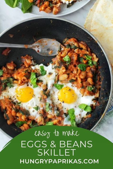 This beans and eggs breakfast or brunch skillet is a winner because just look at the ingredients list! Wholesome nutritious spinach and beans, cooked in a delicious tomato sauce with onions and garlic. And that dreamy egg yolk to mop up with a crusty piece of bread. What's not to love? | how to make eggs and beans skillet | brunch recipe Egg Beans Breakfast, Beans Eggs Breakfast, Bean And Egg Recipes, Beans And Eggs Recipe, Eggs And Black Beans, Eggs And Beans Recipes, Eggs Rice And Beans Breakfast, Eggs And Beans Breakfast, Bean And Egg Breakfast