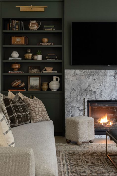 Shadow Avenue Living Room Revival | Ayesha Usman Design Closed Storage Living Room, Terrace Living Room Ideas, Moody Tv Room, Built In Shelves Living Room Fireplace, Fireplace With Bookshelves, Painted Built Ins, Living Room Mantle, Terrace Living Room, Fireplace Bookshelves