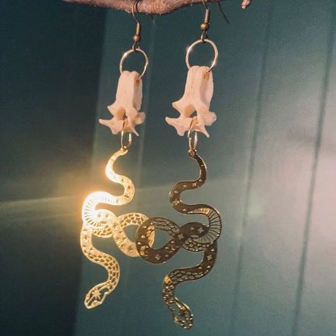 Possum Vertebrae Bone Gold Snake Pendant Earrings - Ethically sourced - Available for purchase on Poshmark and Mercari. Check my bio for the links to them. #goth #gothic #gothicstyle #gothicfashion #gothfashion #punkstyle #festivalfashion #grungestyle #grungefashion #poshmarkseller #poshmark #mercari #mercariseller #taxidermy #taxidermist #vultureculture #bones #oddities #oddity #animalbone #animalbones #animalbonejewelry #vulturecultureart #vultureculturejewelry #postapocalyptic #avantgard... Animal Bone Jewelry, Vampire Freaks, Punk Rock Grunge, Western Wild, Wild West Cowboys, Vulture Culture, Skeleton Bones, Cowgirl Aesthetic, Bone Jewelry