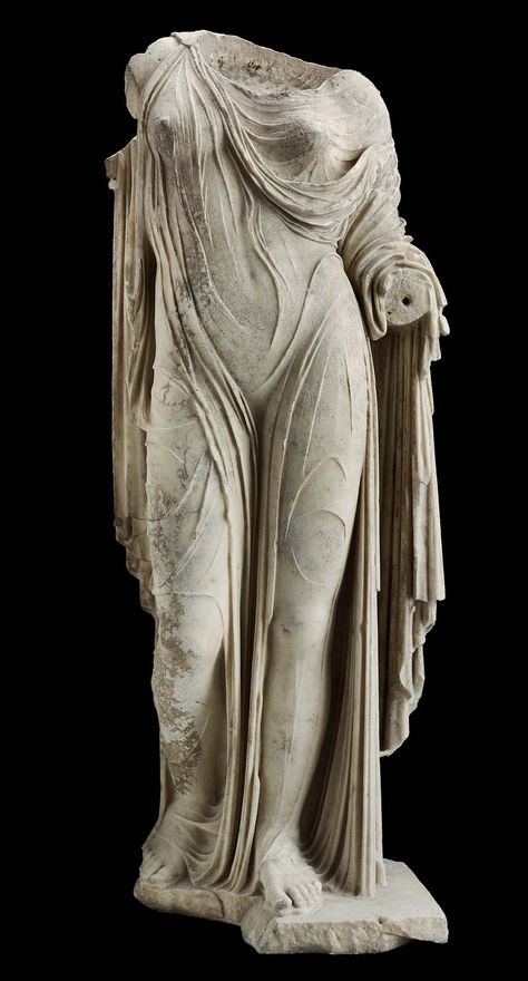 The plinth is broken away in front of the right foot. The right arm and right shoulder were made separately and attached with a large pin or clamp. The drapery is chipped. The surfaces are incrusted and have a yellowish patina.Statue of Aphrodite or a Roman lady  Roman Imperial Period about mid-1st century A.D. Statue Of Aphrodite, Ancient Greek Sculpture, Istoria Artei, Roman Statue, Classic Sculpture, Ancient Statues, Roman Sculpture, Greek Sculpture, Ancient Sculpture