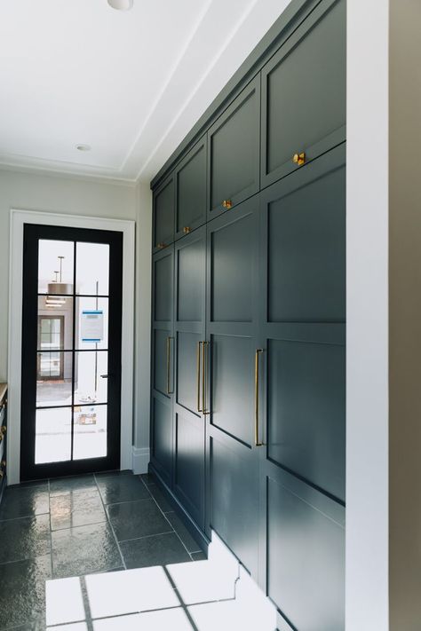 Built in floor-to-ceiling storage space with dark blue green cabinetry and gold cabinet pulls. | shorelineconstructionsc.com To Ceiling Cabinets, Hallway Storage Cabinet, Ceiling Cabinets, Cabinets To Ceiling, Floor To Ceiling Cabinets, Gold Cabinet Pulls, Mudroom Cabinets, Mudroom Flooring, Wall Storage Cabinets