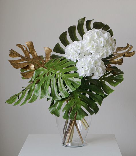 We always wanted to play with leafs and greens but have been so busy with everyday tasks that we kept putting it off. Anyway, here it is! Hydrangeas and Monstera arrangement. The monstera is available from the sale which is opened this weekend (Aug 24/25). Price with Vase 7140 THB Dimension : H 80 cm x L 68 cm This vase is a one off. If it is purchased, recreating is possible but usually the vase is sourced by the client. Monstera Arrangement, Leaf Flower Arrangement, Boquette Flowers, Mood Images, Rose Arrangements, Leaf Flower, So Busy, The Client, White Roses