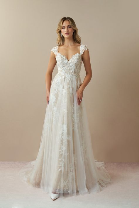 Moonstone is our bridal gown that embodies an ethereal and romantic look. She features a V-neckline with illusion tulle cap sleeves embellished with floral lace applique, that trails down to the A-line skirt with a hint of sparkle. We designed this with a low illusion V-back and a chapel length train for added drama as you walk down the aisle. Chapel Train Wedding Dress, Short Sleeve Wedding Dress, Wedding Dress Cap Sleeves, Wedding Dress Flowy, White Champagne, Pretty Wedding Dresses, Wedding Dress Lace, Floral Wedding Dress, Wedding Dress Train