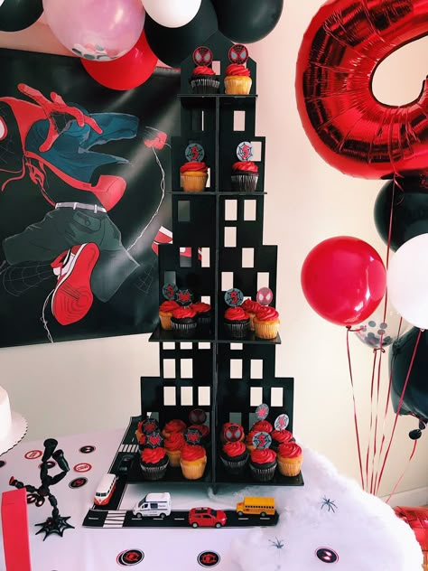 Skyline Cupcake holder + custom cupcake toppers Miles Morales themed birthday party Credit: @wokeartmom on IG. #birthdaypartythemes #milesmorales #spiderman #birthdaypartyideas Spiderverse Themed Party, Black Spider Man Party Ideas, Miles Morales Goodie Bags, Miles Morales Decorations, Spider Man Miles Morales Birthday Party Ideas, Spiderman Birthday Party Miles Morales, Miles Morales Theme Party, Miles Morales Spiderman Party, Miles Morales Party Favors