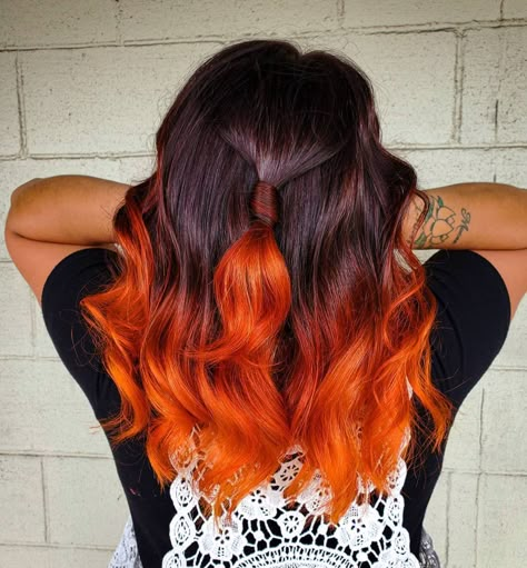 Hair colorist, Bre Ellis (@breellisofficial), painted a bright orange shade on the dark mane's ends, creating an eye-catching autumn hair. Wants this? Visit our website for more dark ombre styles! #darkombrehair #darkombrehaircolor Hair Color Ideas For Brunettes Orange, Dark Hair With Orange Underneath, Orange Balayage Hair Dark Brown, Orange Ends Hair, Balayage Hair Vivids, Dark Red Hair With Orange Highlights, Black To Orange Ombre Hair, Brown To Orange Hair, Brown To Orange Ombre