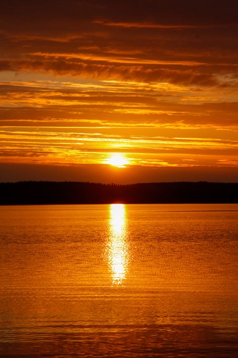 Intense sunset with orange glow over natural lake in Finland. Light reflections of sunset over water surrounded by hills Art Assessment, Moon Board, Ducks Unlimited, Orange Sunset, Lake Water, Water Reflections, Lake Como, Scenery Wallpaper, Phone Backgrounds