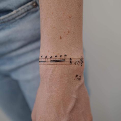 Music Note Wrap Around Tattoo, Note Music Tattoo, Tato Music, Meaningful Music Tattoos, Music Arm Tattoo, Marching Band Tattoos, Tattoos For Musicians, Music Sheet Tattoo, Classical Music Tattoo