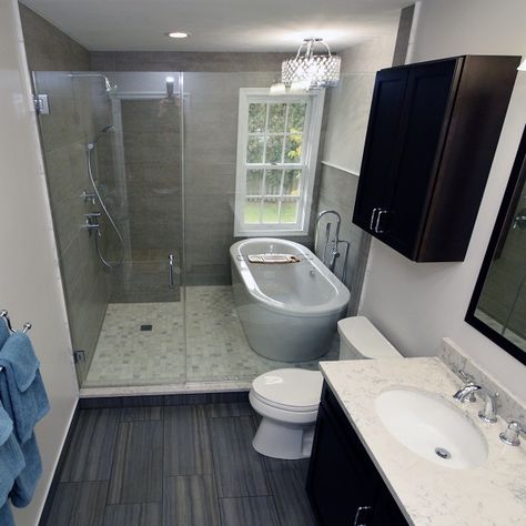 This lovely spacious home on a tree lined street, concealed a master bathroom fit for a scary movie.  

The space required a dramatic redesign. After removing everything to the framing, we created a “wet room” in the back half of the space. Behind the heavy plate glass door and wall, we placed a free standing tub (complete with chandelier) under the window. The balance of the area became a large open shower. With all of the obstructions gone, the bathroom is spacious and visually unobstructed. Tub Inside Shower Layout Wet Rooms, Tub Inside Shower Layout, Doorless Showers Walk In, Freestanding Tub Shower Combo, Shower No Door, Walk In Shower No Door, Bathroom Tub Shower Combo, Walk In Shower Ideas, Wet Room Bathroom