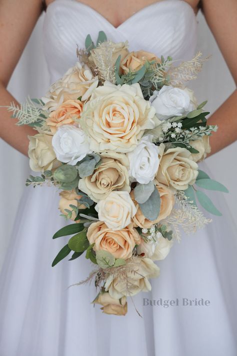 This lovely assortment of champagne, white, cream and sad is bound to turn heads on your wedding day. This lovely cascading brides’ bouquet from the is an absolutely breathtaking arrangement for any bride to be, in any season. Sage greenery and pampas grass complete the look and add a delicate realism to this beautiful bouquet. This bouquet is 10” wide, 18” long, and is crafted by our in-house florists without using a foam base to anchor the flowers to the bouquet. Instead, we wire our bouquets Bouquet With Pampas, Small Bridesmaid Bouquets, Fake Wedding Flowers, Sage Eucalyptus, Fresh Wedding Flowers, Classy Makeup, Fake Wedding, Budget Bride, Makeup Images