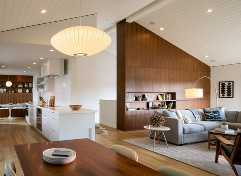 Custom walnut shelves and storage units match wide-plank white oak on the floors. A curved floor lamp by CB2 adds to the midcentury vibes. Mid Century Remodel, Midcentury Home, Mid Century Modern House, Prefab Homes, A Living Room, Mid Century House, Decoration Design, 인테리어 디자인, A Kitchen