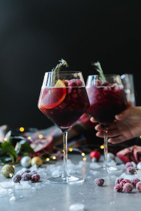 This Christmas Sangria is the most festive red sangria recipe for all of your holiday celebrations! It's the best red sangria ever, and SO easy to make. It's made with your favorite red wine, a touch of cinnamon simple syrup, pomegranate juice, cranberry juice, a little orange liqueur, pomegranate arils, sliced oranges, honeycrisp apples, and fresh cranberries! #sangria #cocktail #christmas #holidayrecipe Holiday Sangria Recipes, Thanksgiving Sangria, Cranberry Sangria, Red Sangria Recipes, Winter Sangria, Holiday Sangria, Cinnamon Simple Syrup, Christmas Sangria, Red Wine Sangria