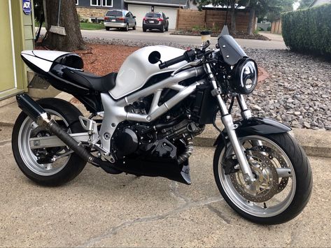 This is my own custom motorcycle I built from an old SV650s. It is a three stage pearl white and black. Sv650 Cafe Racer, Suzuki Sv650 Custom, Suzuki Sv 650 S, Virago Cafe Racer, Suzuki Sv 650, Suzuki Cafe Racer, Suzuki Bikes, Cafe Bike, Cafe Racer Bikes