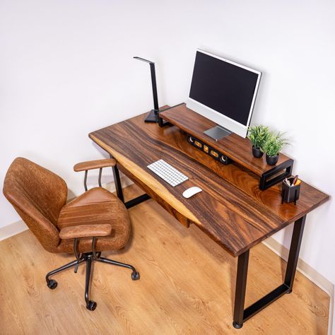 Live Edge Desk - Ships Next Business Day For Free. Transform your workspace with our Computer Desk, designed for elegance and functionality. Perfect for work-from-home setups and office environments, this Walnut Desk blends natural beauty with practical features. Key Features: ∙ Premium Material: Made from solid walnut wood, this desk showcases a unique natural live edge, making each piece one-of-a-kind. ∙ Customization Options: Choose between different size options, a desk with drawer, or a desk shelf to suit your needs. **Please note 30in desk doesn't come with adds-on" ∙ Handmade Quality: Expertly handcrafted, ensuring meticulous attention to detail and superior craftsmanship. ∙ Natural Live Edge: Each wood desk features a natural live edge, adding a touch of nature to your workspace. ∙ Desk With Shelf, Live Edge Desk, Computer Stand For Desk, Live Edge Design, Desk With Keyboard Tray, Desk With Drawer, Walnut Desk, Computer Desks For Home, Wood Computer Desk