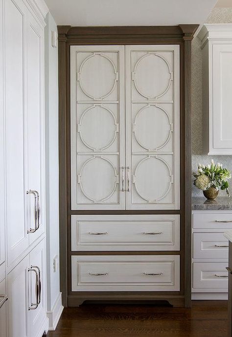 If you are looking for something unique and elegant, check out this decorative refrigerator door panel! A light gray paneled refrigerator door is decorated with an ornate wood shaped pattern showcasing stunning symmetry. Modern Refrigerator, Paneled Refrigerator, Refrigerator Panels, Steel French Doors, Light Gray Cabinets, Built In Hutch, Quartz Backsplash, Grey Kitchen Island, Kitchen Transitional