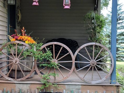 I used wagon wheels for porch rails. The wheels belonged to my mother before she passed Wagon Wheel Porch Railing, Porch Rails, Cottage Porch, Wagon Wheels, Rustic Porch, Porch Railing, Wagon Wheel, To My Mother, Country Charm