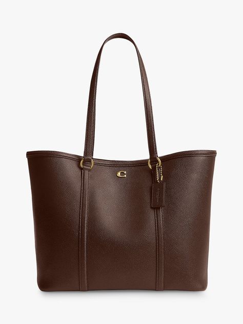 The classic tote reimagined for the new season, pick this trusty piece from Coach. Whipped up from smooth and dreamy leather that's made to last, it fastens with a magnet. Uni Bags Handbags, Coach Bag Brown, Coach Bags Tote, It Bags 2024, Brown Purse Aesthetic, Leather Tote Bag Aesthetic, Cute Bags Aesthetic, Bags For Uni, Handbags For College